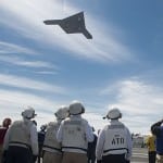 The X-47 overflying an aircraft carrier last year. Photo: U.S. Navy