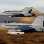An E/A-18 Growler in the foreground shadowed by a F/A-18 Super Hornet. Photo by Boeing.