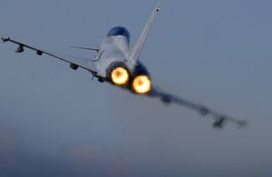 A Typhoon F2 fighter jet pilot applies the throttle as the aircraft pulls away from RAF Coningsby