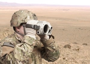 Spc. Jonathan Low scan the horizon from a hilltop