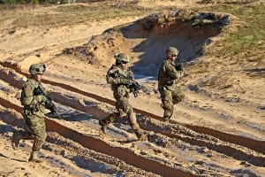 Soldiers of two armies hustle mortars in the sand
