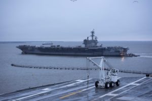 Tugboats assist the aircraft carrier USS George H.W. Bush as it transits the Elizabeth River on its way to the Norfolk Naval Shipyard to undergo a 28-month long Docking Planned Incremental Availability (DPIA). (Photo: U.S. Navy)