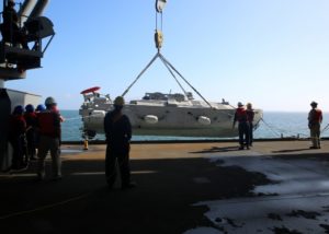 U.S. Navy Sailors and civil service mariners launch an unmanned surface vehicle (USV) mine countermeasure platform from the expeditionary sea base USNS Hershel “Woody” Williams (T-ESB 4), into the Chesapeake Bay on September 14. This was the first time a USV was launched and recovered from a Navy ship. (Photo: U.S. Navy)