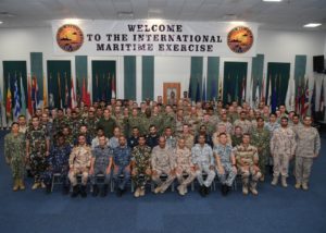 International Maritime Exercise (IMX) 2019 staff members pose for a photo during the opening ceremony of IMX 2019 at Naval Support Activity Bahrain. (Photo: U.S. Navy)