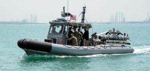 Remus 600 medium unmanned underwater vehicle being carried on stern of a small patrol craft. (Photo: Hydroid Inc., now a division of HII)