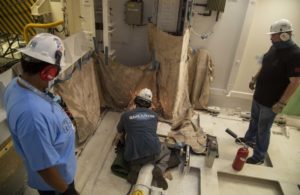 A Huntington Ingalls Industries Newport News Shipbuilding engineer grinds in USS Gerald R. Ford's (CVN-78) Lower Stage Weapons Elevator 1 on July 18, 2020, during final days prior to certification. (Photo: U.S. Navy)