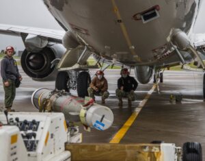 Aviation Ordnanceman 3rd Class Evan Tu’ua, right, Chief Aviation Ordnanceman Ryan Ward, center, and Aviation Ordnanceman Airman Mason Cleveland, assigned to the “Screaming Eagles” of Patrol Squadron (VP) 1, load a Mark 54 torpedo onto a P-8A Poseidon aircraft during a scheduled exercise in July 2020. (U.S. Navy photo by Mass Communication Specialist 3rd Class Dylan Sharp)