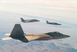 A U.S. Air Force F-22 Raptor and F-35A Lightning II fly in formation with the XQ-58A Valkyrie low-cost unmanned aerial vehicle over the U.S. Army Yuma Proving Ground testing range, Ariz., during a series of tests Dec. 9, 2020. This integrated test follows a series of gatewayONE ground tests that began during the inaugural Department of the Air Force on-ramp in December, 2019. (Air Force Photo)