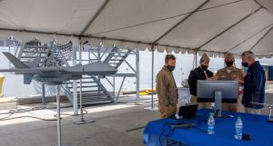 Vice Adm. Michael Moran, principal military deputy assistant Secretary of the Navy (Research, Development and Acquisition), speaks with representatives from General Atomics Aeronautical about the MQ-9 Sea Guardian unmanned aircraft atNaval Base San Diego on April 15 ahead of U.S. Pacific Fleet’s UxS IBP 21 exercise from April 19-26 (Photo: U.S. Navy by Mass Communication Specialist 2nd Class Natalie M. Byers)