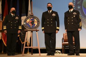 Chief of Naval Operations, Adm. Michael Gilday, left; Rear Adm. F.R. Luchtman, commander, Naval Safety Command, middle; and Master Chief Jimmy Hailey, command master chief for the Naval Safety Command, right, reveal the new seal for the Naval Safety Command during the command establishment ceremony. (Photo: U.S. Navy by Mass Communication Specialist 2nd Class (SW/AW) Weston A. Mohr)