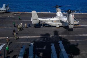 Senior military leadership cross the flight deck of the USS Carl Vinson (CVN-70) to board a CMV-22B Osprey, assigned to Fleet Logistics Multi-Mission Squadron (VRM) 30 on Feb. 9, 2022. At the time, the carrier was conducting routine maritime operations in 3rd Fleet area of operations. (Photo: U.S. Navy by Mass Communication Specialist 3rd Class Megan Alexander)