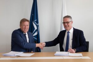 Leidos Senior Vice President and C4ISR Operations Manager Michael Rickels (left) and NCI Agency General Manager Ludwig Decamps (right) attend a signing ceremony agreement on March 30, 2022 for contracting Leidos to support NATO upgrading its ballistic missile defense capabilities. (Photo: NCI Agency).