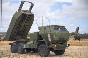 U.S. Marines with 5th Battalion, 11th Marine Regiment set up an M142 High Mobility Artillery Rocket System (HIMARS) in front of an AN/TPS-80 Ground/Air Task Oriented Radar with Marine Air Control Group (MACG) 18 at Andersen Air Force Base, Guam, June 13, 2022, in support of Valiant Shield 2022. (Photo: U.S. Marine Corps by Cpl. Tyler Harmon)