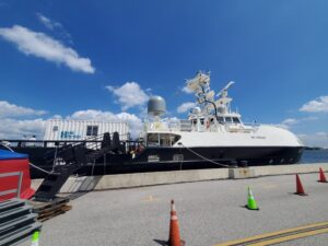 The Mariner Ghost Fleet Overlord Unmanned Surface Vessel moored at the U.S. Naval Academy in Annapolis, Md. on Aug. 22, 2022. Two 20-foot payloads sit at the front of the payload deck. (Photo: Richard Abott, Defense Daily)