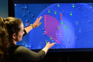 Various representative aircraft, as well as ships and other naval assets, are shown in a mission space during a summer 2022 Boeing virtual simulation of how other aircraft can control an MQ-25 to task it for tanking and intelligence, surveillance and reconnaissance missions without traditional ship-based ground control communications. (Photo: Boeing)