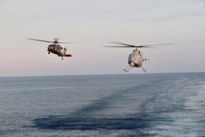 An MH-60S Seahawk and MQ-8C Fire Scout unmanned aerial vehicle, assigned to Helicopter Sea Combat Squadron (HSC) 23, conduct concurrent flight operations as a manned-unmanned team (MUM-T) while embarked on the Independence-variant littoral combat ship USS Jackson (LCS-6) while operating in the South China Sea on May 19, 2022. (Photo: U.S. Navy by Lt. j.g. Alexandra Green)