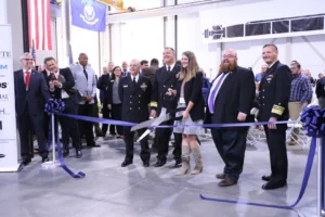 Military leaders cut the ribbon at the Navy’s new Additive Manufacturing Center of Excellence (CoE) in Danville, Va. on Oct. 5, 2022. From left: Rear Adm. Jason M. Lloyd, chief engineer and deputy commander, Ship Design, Integration and Naval Engineering, Naval Sea Systems Command (NAVSEA); Rear Adm. Scott Pappano, program executive officer, Strategic Submarines (PEO SSBN); Whitney Jones, director, Submarine Industrial Base; Matt Sermon, executive director, PEO SSBN; and Vice Adm. William Galinis, commander, NAVSEA. (Photo: U.S. Navy courtesy of Institute for Advanced Learning and Research)