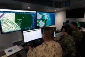 Royal Canadian Navy Lt. Cmdr. Brian MacMillan, left, Intelligence Specialist 1st Class Samantha Jordan, center, and UK Royal Navy Lt. Andrew Burns, participate in Digital Horizon 2022 in the Task Force 59 Robotics Operations Center on Nov. 28, 2022. (Photo: U.S. Navy by Mass Communication Specialist 1st Class Anita Chebahtah)