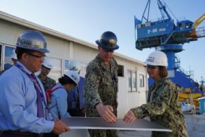 Vice Chief of Naval Operations Admiral Lisa Franchetti discusses plans for infrastructure improvements under the Shipyard Infrastructure Optimization Program (SIOP) with Shipyard Commander Captain Richard Jones, and Production Facilities and Plant Equipment Manager Chad Nakamoto at Pearl Harbor Naval Shipyard & Intermediate Maintenance Facility (PHNSY & IMF) during a visit for an operations update and SIOP tour onboard Joint Base Pearl Harbor-Hickam. (Photo: U.S. Navy by Justice Vannatta/Released)