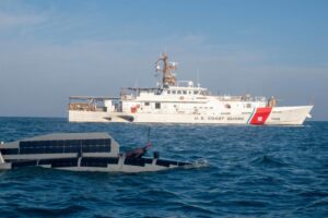 An Ocean Aero Triton unmanned surface vessel operates alongside the U.S. Coast Guard fast response cutter USCGC Emlen Tunnell (WPC-1145) in the Arabian Gulf on Nov. 29, 2022 during Digital Horizon 2022. (Photo: U.S. Army by Sgt. Brandon Murphy)