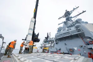 Sailors aboard Arleigh Burke-class guided-missile destroyer USS Spruance (DDG-111) guide training ordnance into the ship’s forward vertical launch system (VLS) cells during a proof-of-concept evolution in San Diego, Oct. 4, 2022. MV Ocean Valor conducted its first at-sea vertical launch system reload with Spruance, demonstrating the ability of the U.S. Navy to re-arm surface vessels who employ VLS. (Photo: U.S. Navy by Mass Communication Specialist 3rd Class Taylor Crenshaw)