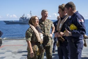 Vice Chief of Naval Operations and acting CNO Adm. Lisa Franchetti, Commandant of the Marine Corps Gen. Eric Smith, and Royal Navy First Sea Lord and Chief of Naval Staff Adm. Sir Ben Key, tour the HMS Prince of Wales (R09) on Oct. 18, 2023 . While aboard they signed the Delivering Combined Seapower (DCS) charter, that aims for increased interoperability and towards interchangeability. (Photo: U.S. Navy by Chief Mass Communication Specialist Amanda R. Gray)