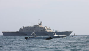 The littoral combat ship USS Indianapolis (LCS 17) sails with two T-38 Devil Ray unmanned surface vessels (USV) and an Arabian Fox MAST-13 USV, all attached to U.S. Naval Forces Central Command’s (NAVCENT) Task Force 59, during exercise Digital Talon 2 in the Arabian Gulf, Nov. 27. (Photo: U.S. Army by Sgt. Marita Schwab)