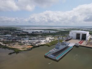 A company graphic rendering of what the Austal USA new steel production facility and shiplift capabilities will look like once added to its Mobile, Ala. shipyard. This includes hosting a Constellation-class frigate on the shiplift section. (Image: Austal USA)