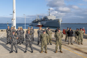 U.S. Navy Sailors assigned to the submarine tender USS Emory S. Land (AS 39), temporarily attached to the Royal Australian Navy (RAN) Fleet Support Unit-West (FSU), and RAN sailors assigned to FSU, stand in formation as the Emory S. Land prepares to moor at HMAS Stirling, Western Australia, Australia on Aug. 16, 2024.(Photo: U.S. Navy by Mass Communication Specialist 2nd Class Darek Leary)