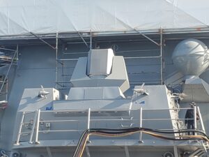 An AN/SEQ-4 Optical Dazzler Interdictor, Navy (ODIN) laser dazzler weapon installed on the USS Spruance (DDG-111) while the ship was docked at Naval Base San Diego in January 2025. The ODIN is in the place where a destroyer usually has a Raytheon Phalanx Close In Weapon System (CIWS). (Photo: Richard Abott/Defense Daily)