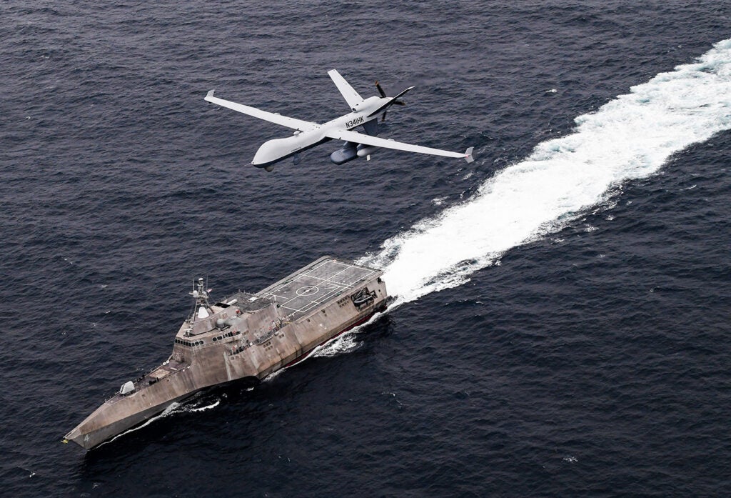 An MQ-9 SeaGuardian unmanned maritime surveillance aircraft system flies over Independence-variant littoral combat ship USS Coronado (LCS-4) during U.S. Pacific Fleet’s Unmanned Systems Integrated Battle Problem (UxS IBP) 21 on April 21, 2021. (Photo: U.S. Navy by Chief Mass Communication Specialist Shannon Renfroe)