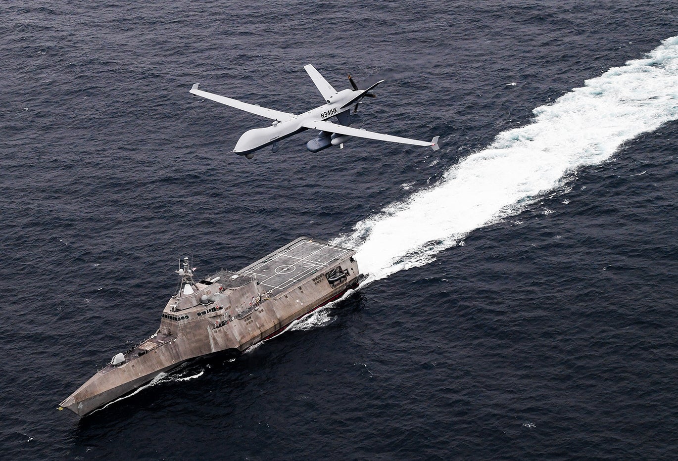 An MQ-9 SeaGuardian unmanned maritime surveillance aircraft system flies over Independence-variant littoral combat ship USS Coronado (LCS-4) during U.S. Pacific Fleet’s Unmanned Systems Integrated Battle Problem (UxS IBP) 21 on April 21, 2021. (Photo: U.S. Navy by Chief Mass Communication Specialist Shannon Renfroe)