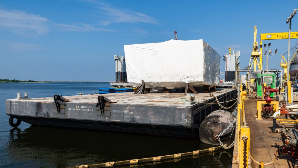A grand block delivery for the future USS Thad Cochran (DDG-135) destroyer at HII’s Ingalls Shipbuilding in August 2025, one piece of HII increasing outsourcing to improve Navy warship shipbuilding rates. (Photo: HII)