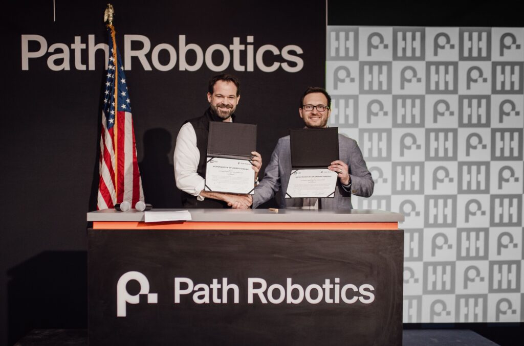 Eric Chewning (left), HII executive vice president of maritime systems and corporate strategy, and Andy Lonsberry (right), CEO and co-founder of Path Robotics, signed a Memorandum of Understanding at the latter's headquarters in Columbus, Ohio on Feb. 17 to explore integrating Path’s AI-based welding solutions into HII’s shipbuilding operations to improve throughput. (Photo: HII)