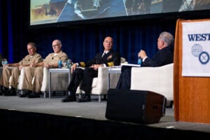 Vice Adm. Brendan McLane, commander, Naval Surface Force, U.S. Pacific Fleet (CNSP), center, speaks on a Feb. 10 panel at the WEST 2026 conference in San Diego. (Photo: U.S. Navy by Mass Communication Specialist 1st Class Claire M. Alfaro)