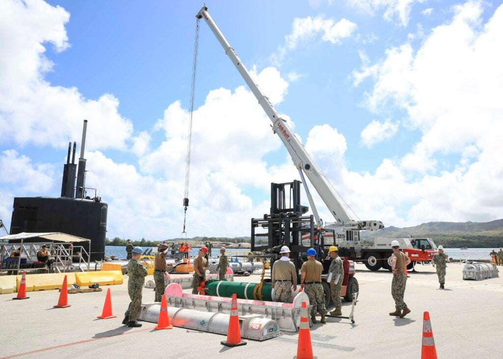Sailors assigned to the Los Angeles-class fast-attack submarine USS Annapolis (SSN 760) load a MK 67 submarine launched mobile mine (SLMM) onto Annapolis, May 4 while in port at Guam in 2022. (Photo: U.S. Navy by Mass Communication Specialist 2nd Class Zachary Grooman).