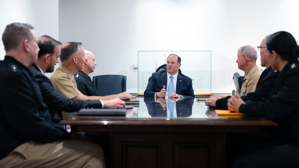 Secretary of the Navy John Phelan speaks with several Navy Department acquisition officials. (Photo: U.S. Navy)